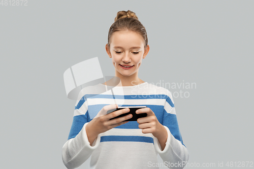 Image of happy smiling teenage girl using smartphone