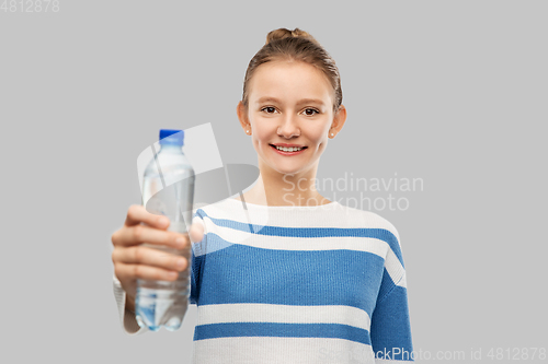 Image of smiling teenage girl with bottle of water