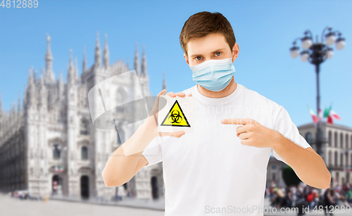 Image of man in medical mask with biohazard sign in italy