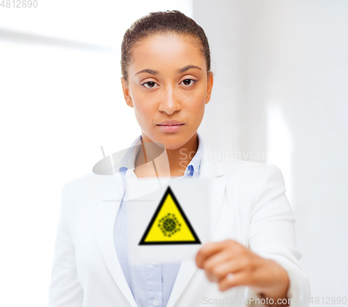 Image of african american doctor with coronavirus sign