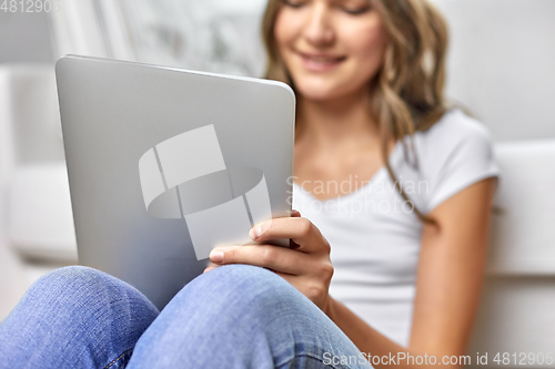 Image of teenage girl with tablet pc computer at home