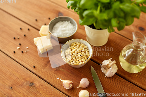 Image of ingredients for basil pesto sauce on wooden table