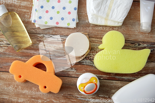 Image of baby accessories for bathing on wooden table