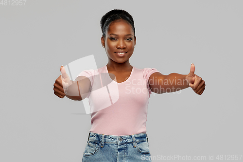 Image of happy african american woman showing thumbs up