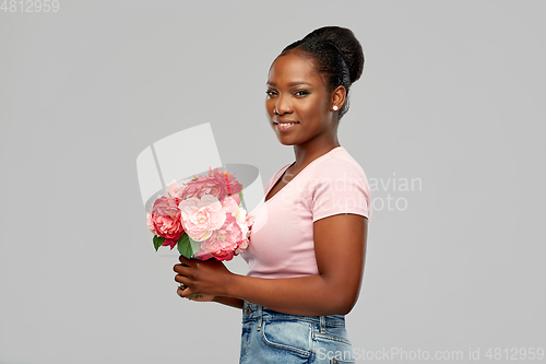 Image of happy african american woman with bunch of flowers