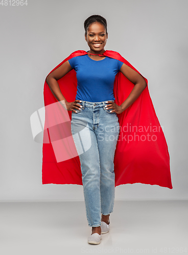 Image of happy african american woman in red superhero cape