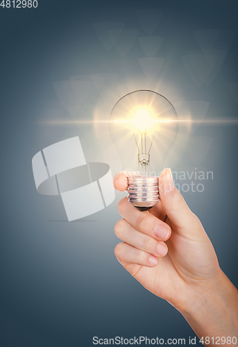 Image of Light bulb in woman hand, concept idea