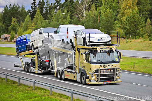 Image of Gold Volvo FM Vehicle Carrier Hauls Cars