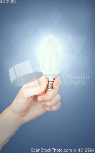 Image of Light bulb in woman hand, concept idea