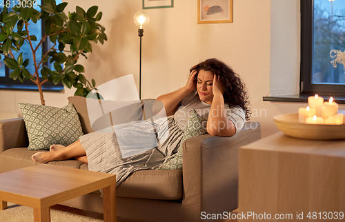 Image of woman suffering from headache at home