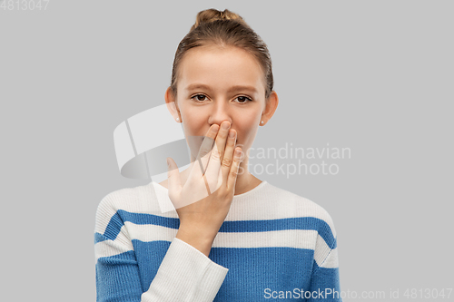 Image of confused teenage girl covering mouth by hand