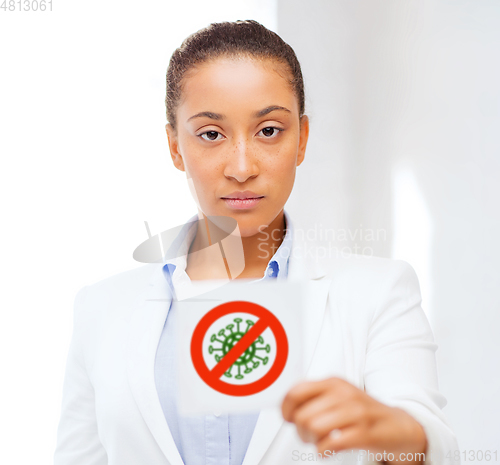 Image of african american doctor with coronavirus sign