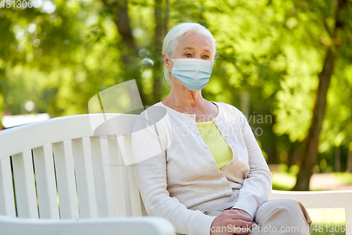 Image of senior woman in protective medical mask at park