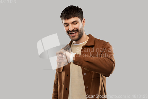 Image of smiling young man with smart watch