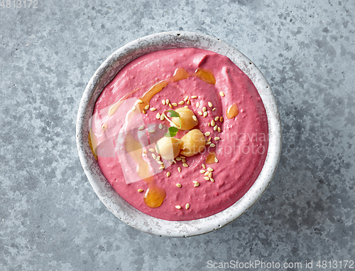 Image of bowl of hummus with beet