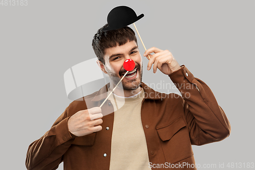 Image of smiling man with bowler hat and red clown nose