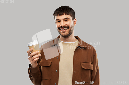 Image of smiling young man with takeaway coffee cup