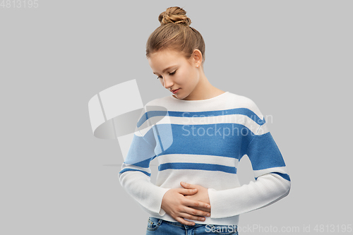 Image of teenage girl having stomach ache