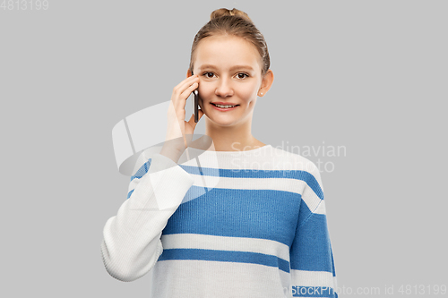 Image of happy smiling teenage girl calling on smartphone