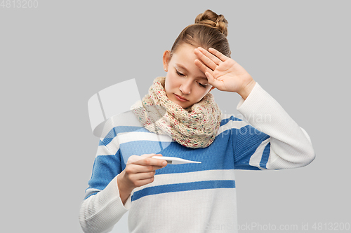 Image of sick teenage girl in scarf measuring temperature