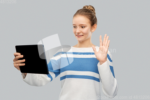 Image of teenage girl with tablet pc having video call