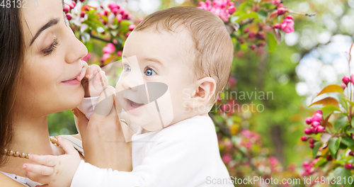 Image of mother with baby over spring garden background