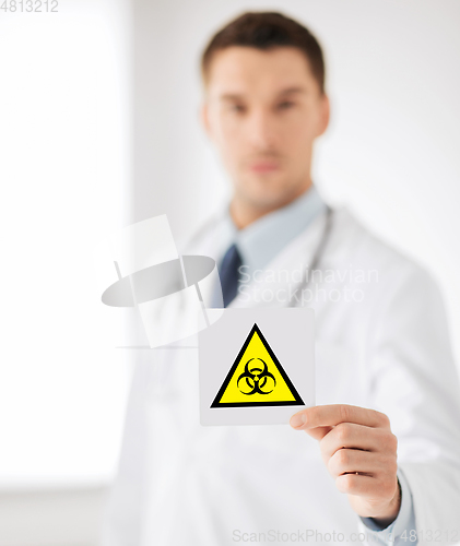 Image of male doctor holding boihazard caution sign