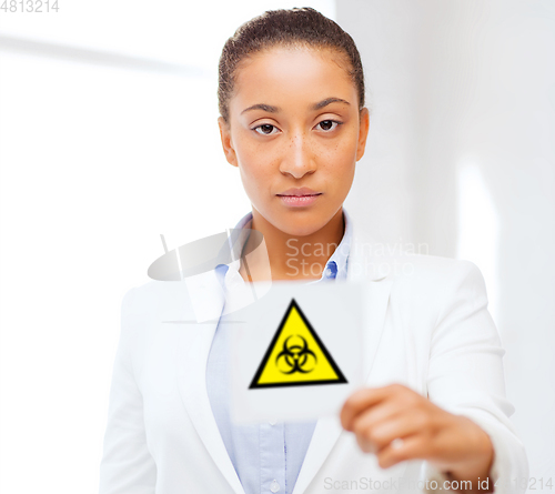 Image of female doctor holding boihazard caution sign