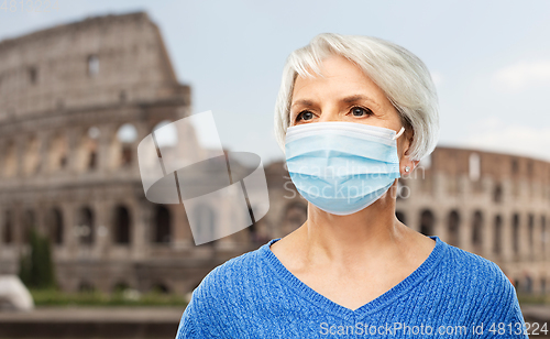 Image of senior woman in protective medical mask in italy