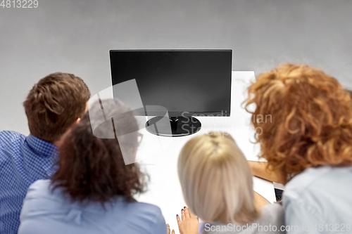 Image of business team with computer working at office