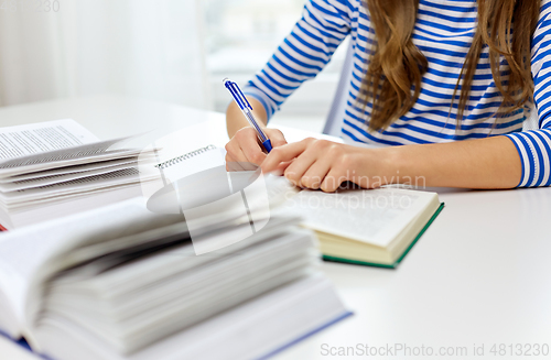 Image of close up of student girl writing to exercise book