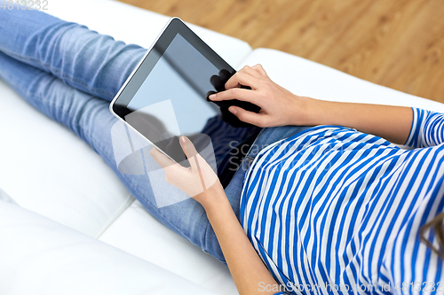 Image of teenage girl with tablet pc computer at home