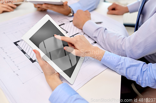 Image of architects with tablet pc and blueprint at office