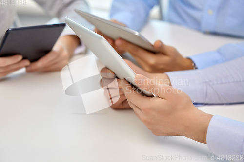 Image of close up of business team with tablet pc at office