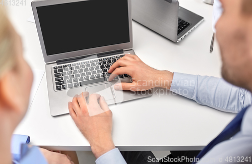 Image of close up of businesspeople with laptop at office