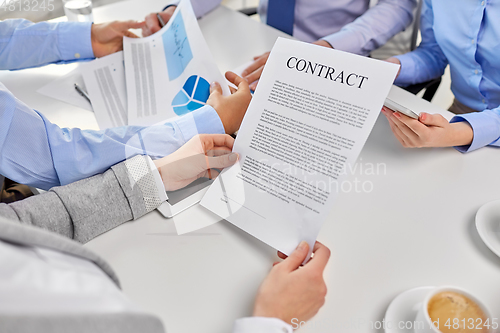 Image of close up of business team with charts and contract