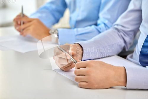 Image of hands of business people at conference at office