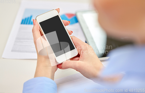 Image of close up of woman with smartphone at office