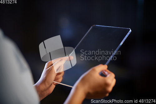 Image of hands with transparent tablet pc computer