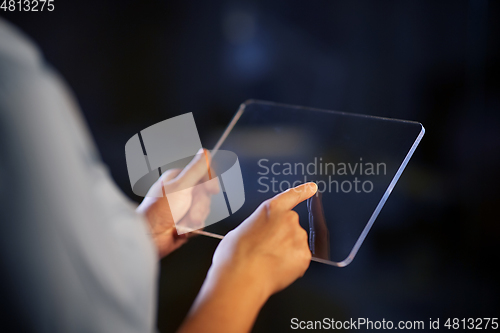 Image of hands with transparent tablet pc computer