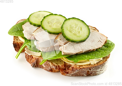 Image of slice of bread with chicken meat and cucumbers