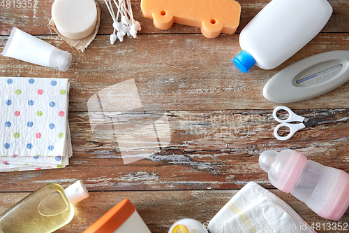 Image of baby accessories for bathing on wooden table