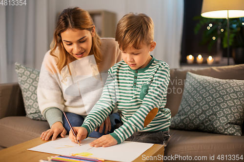 Image of mother and son with pencils drawing at home