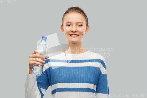 Image of smiling teenage girl with bottle of water