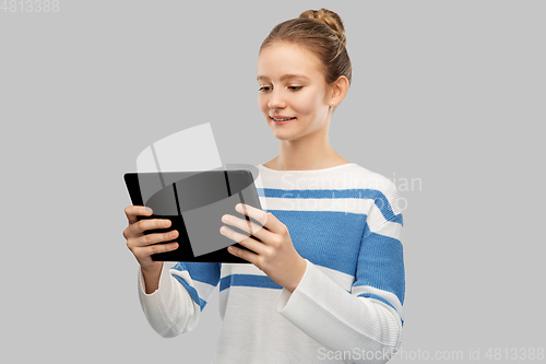 Image of happy smiling teenage girl using tablet computer