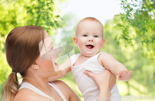 Image of mother with baby over green natural background