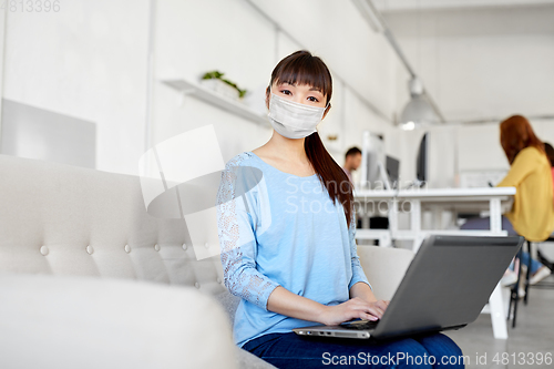 Image of asian woman with laptop in medical mask at office