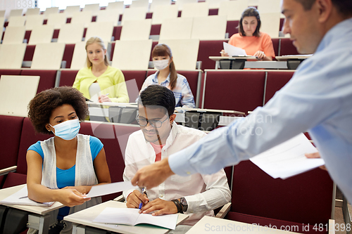 Image of teacher and students in masks at lecture hall