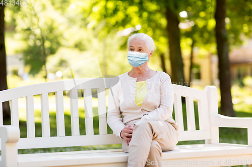 Image of senior woman in protective medical mask at park