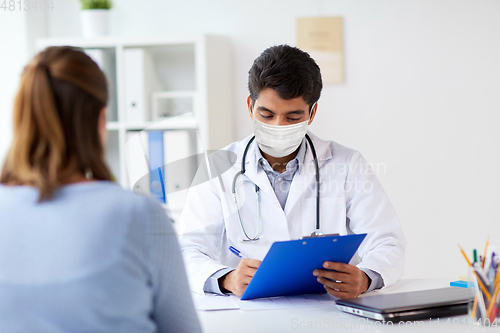 Image of doctor in medical mask and patient at hospital